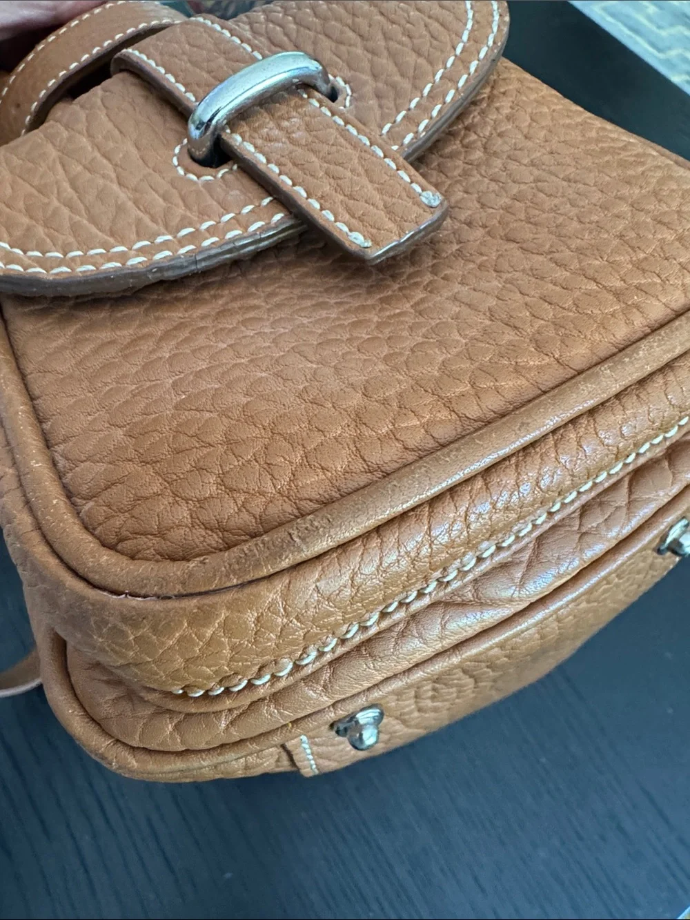 Dooney & Bourke tan pebbled leather side pockets belted satchel bag.